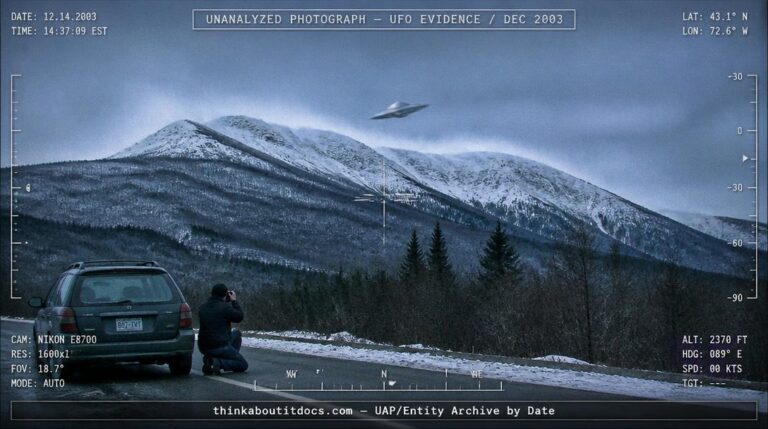 Dossier-style reconstruction of a metallic disc-shaped object against snow-covered Vermont mountains in December 2003 with wind-blown snow plumes and a photographer kneeling beside a car on the roadside below
