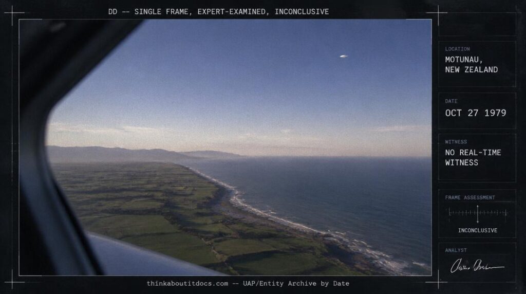 A white disc-shaped object photographed from an aircraft over the rural coastline of Motunau, New Zealand, October 1979