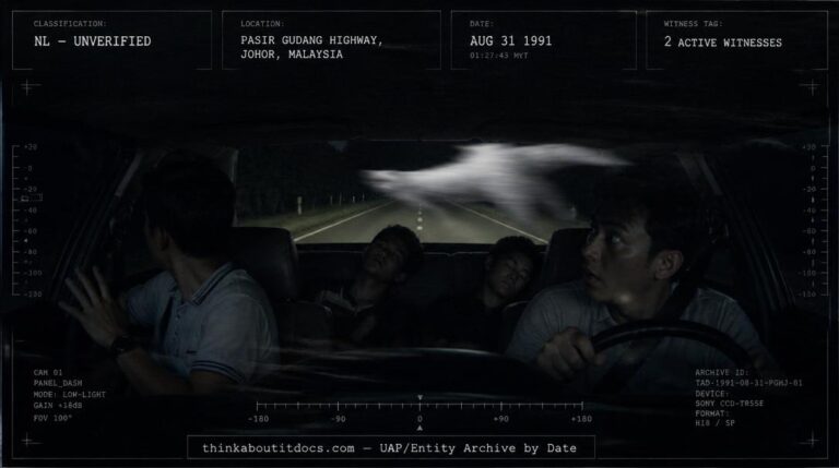 A huge silent silvery-white object crossing a car's path on a dark Malaysian highway at night, August 1991