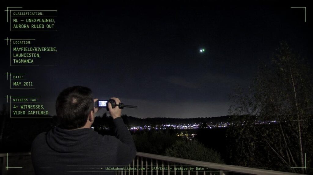 A single white and green flashing light hovering above the treeline near Mayfield, Launceston, Tasmania at night, May 2011