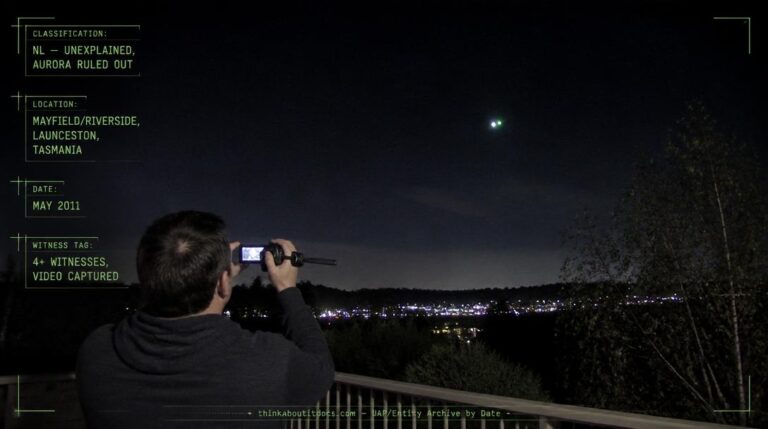 A single white and green flashing light hovering above the treeline near Mayfield, Launceston, Tasmania at night, May 2011