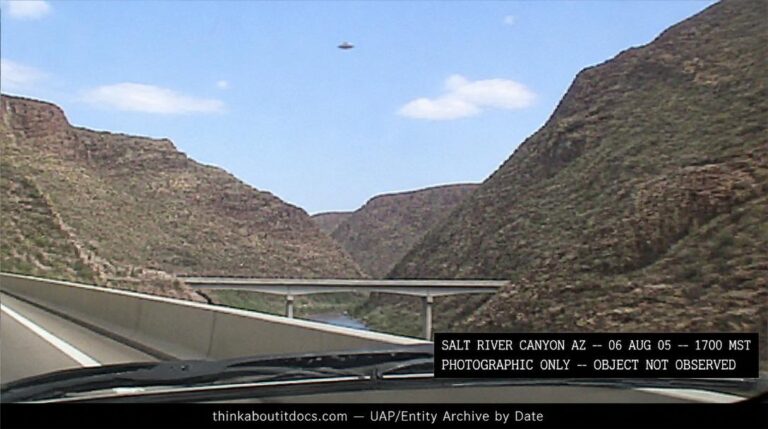 Dossier-style reconstruction of the August 6 2005 Salt River Canyon disc photograph showing a small unresolved disc-shaped object in the sky above the canyon bridge as seen through a car windshield in low-resolution digital camera style