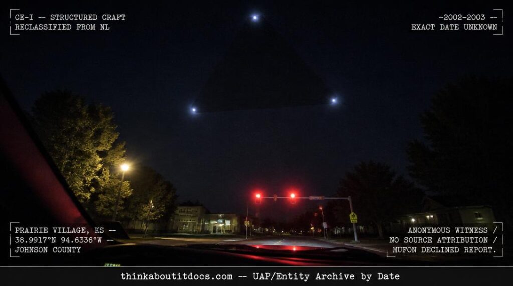Dossier-style reconstruction of the approximately 2002 Prairie Village Kansas hovering triangle sighting showing a dark triangular outline with three pale corner lights seen through a car windshield at a red traffic light with suburban streetscape visible at frame edges and HUD classification reclassification stamps