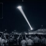 A searchlight beam catches a glowing disc-shaped object over a crowded church carnival in Norwood, Ohio, August 19, 1949