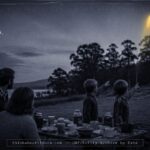 A bright yellow, football-shaped object rising from behind trees near Lake Sorell, Tasmania at dusk, March 1975