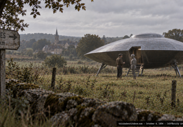 Illustration of a man in calm conversation with a humanoid figure near a landed craft in rural France, October 4, 1954