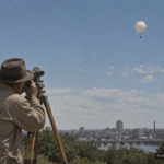 Illustration of a Weather Bureau meteorologist tracking a silvery disc alongside a weather balloon through a theodolite, Richmond, Virginia, April 1947