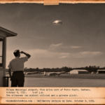Vintage 1951 press photo style image of an airport official watching a small round silver object streak overhead at Hulman Field, Terre Haute, Indiana