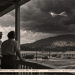 1950-style photo of two men on a porch watching a bright bow-tie shaped aluminum object under a thunderhead at Redstone Arsenal