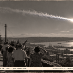 1950-style photo of people on a hillside watching a bright ball of fire streak across the daytime sky over Puget Sound