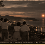 Five people on a cliff above Mayagüez Bay watching two bright orange spheres over the ocean at dusk in 1952.