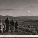 1950-style photo of a family watching a low silvery-white object over sagebrush hills near East Ely, Nevada