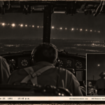 1950-style photo of a B-25 crew watching a string of bright lights crossing the night sky over Colorado